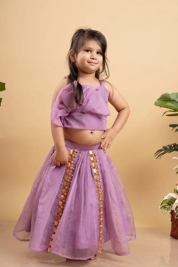 Chic Lavender lehenga with an asymmetrical top, adorned with gold and pink embellishments for a modern festive look.
